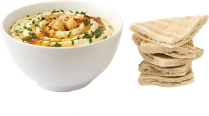 Un bol de hummus con una pila de pan de pita caliente